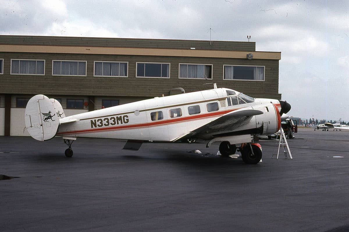 A Beechcraft Super 18 on the tarmac at an airport.